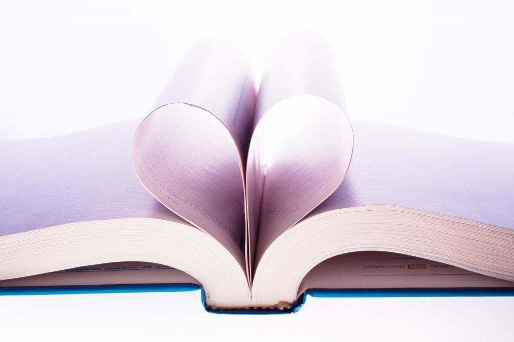 Image of an open book with center pages rolled back to create a heart shape. Habits like reading can make a huge difference.