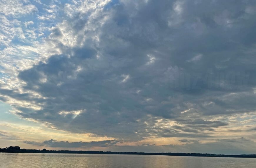 Clouds above the sunset on a lake - a holiday scene