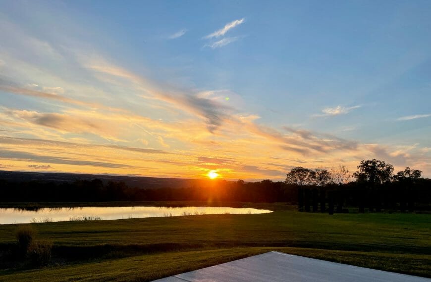 Orange sunset with clouds over a lake