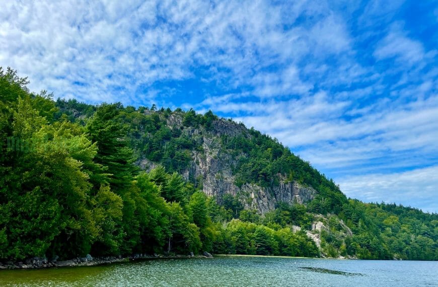 Bright blue sky and green cliffs above the ocean look like an inspiring vacation photo