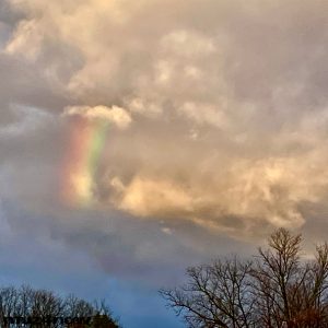 A rainbow drifting in rain clouds