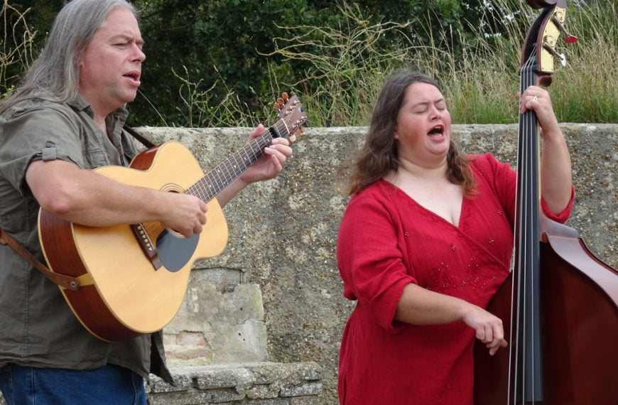 David and Clare Rozzell playing guitar and bass while singing