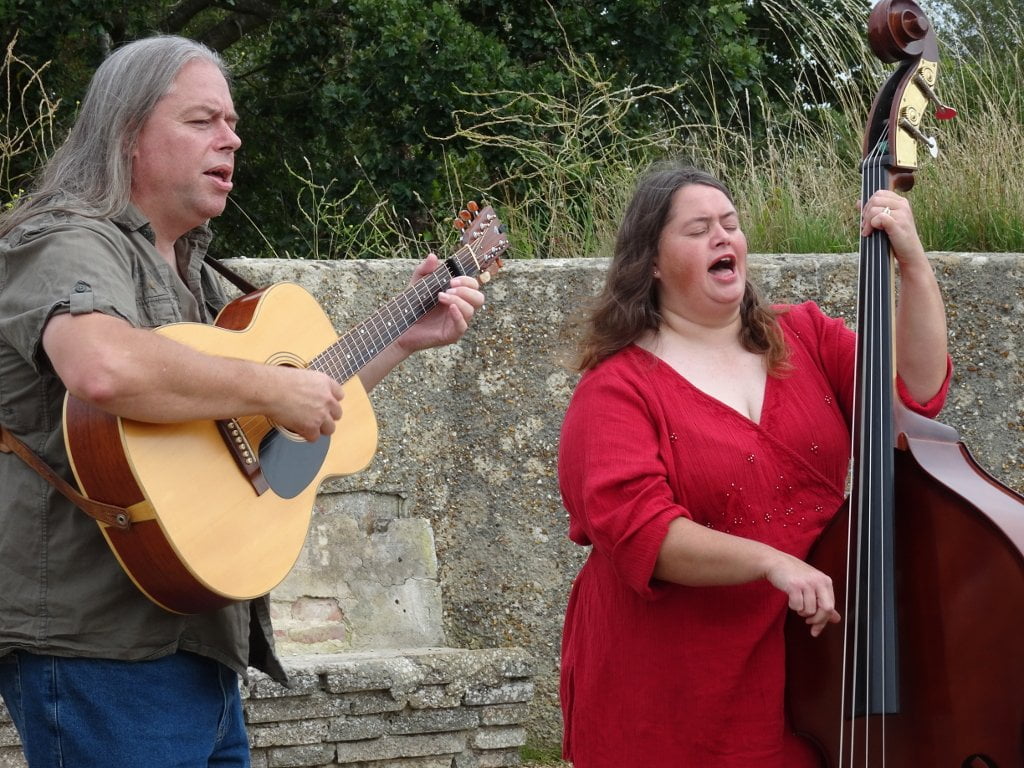 David and Clare Rozzell playing guitar and bass while singing