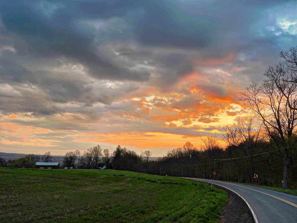 Inward healing takes time - bright orange sunrise through gray clouds.