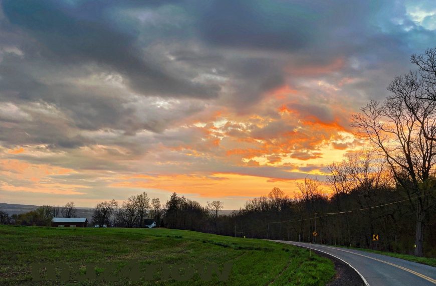 Inward healing takes time - bright orange sunrise through gray clouds.