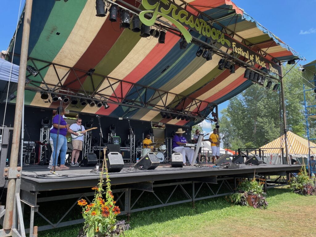 A soul band plays a concert at an outdoor stage at Grassroots music festival.