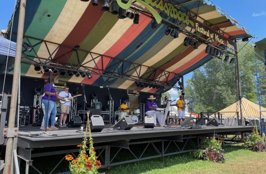 A soul band plays a concert at an outdoor stage at Grassroots music festival.