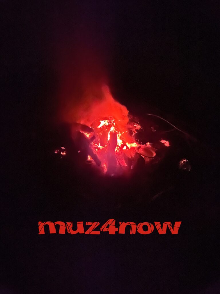 Flames burn over bright, hot coals. World on fire.