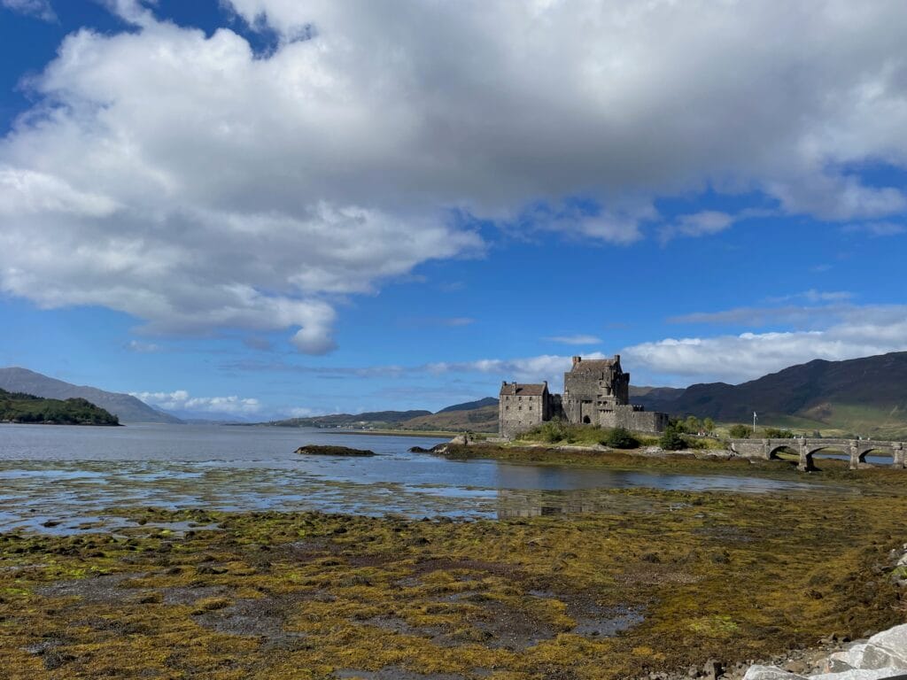 Dunin Castle in the Scottish Highlands is surrounded by a lake (loch).