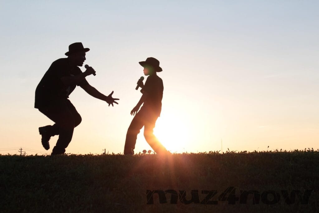 Two singers with microphones, tracking across the horizon are silhouettes against the setting sun.
Photo is by Dawnyell Reese.
https://pixabay.com/users/dawnyellreese-8556131/