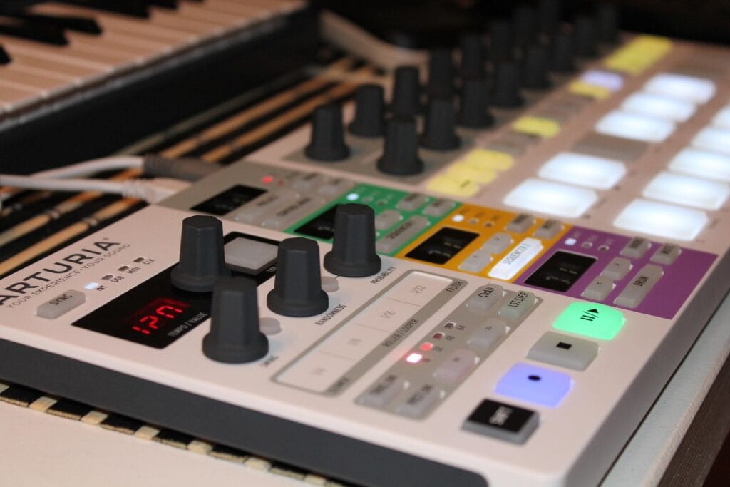 Knobs and pads for programming a synthesizer. The brand name on the controller says "ARTURIA".
Photo source: https://pixabay.com/users/rotten77-45238/