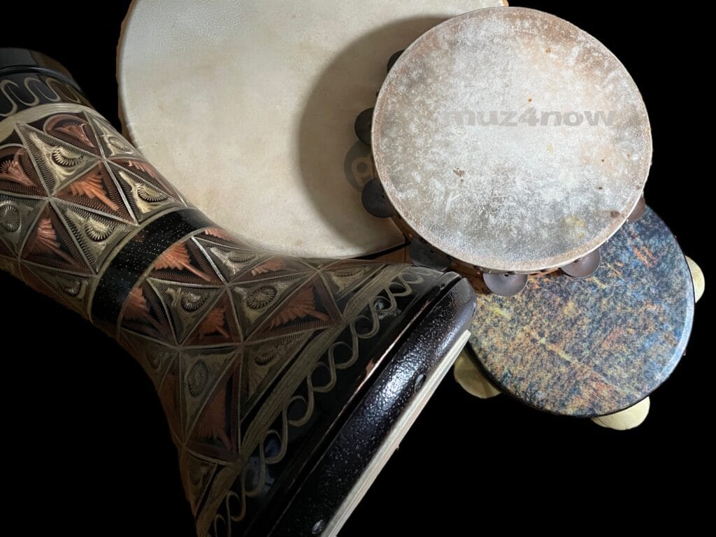 Four (4) hand drums -- a daf, tambourine, riqq, and darbuka -- waiting to be played