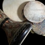 Four (4) hand drums -- a daf, tambourine, riqq, and darbuka -- waiting to be played