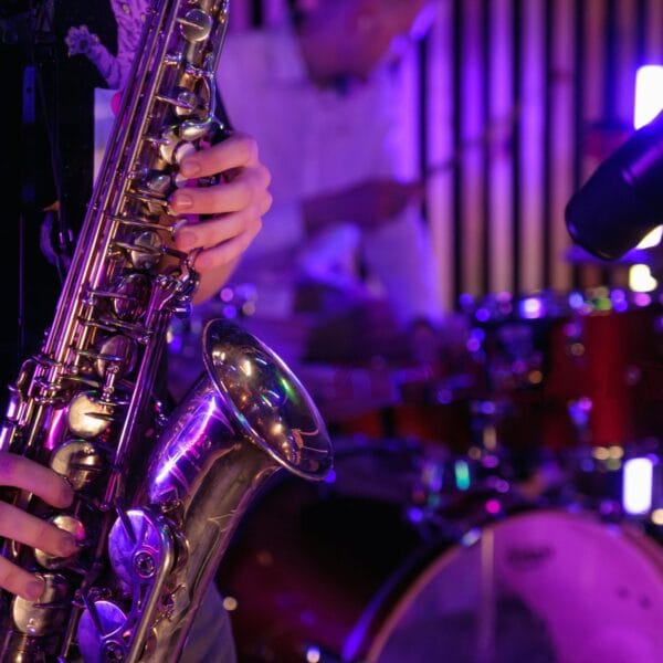 For 3 unsigned musicians: a saxophone being played near a drum kit.