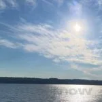 The sun through clouds, over a lake is like medicine for someone grieving.