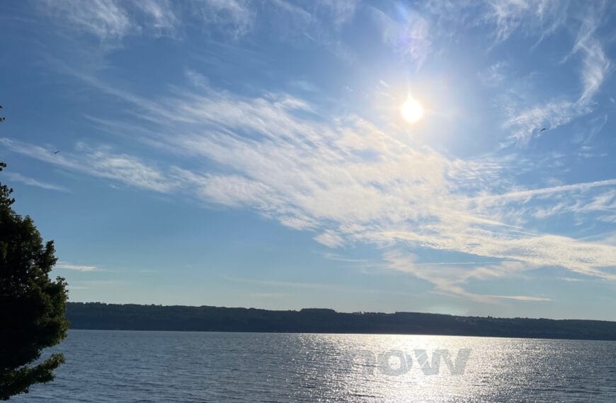 The sun through clouds, over a lake is like medicine for someone grieving.