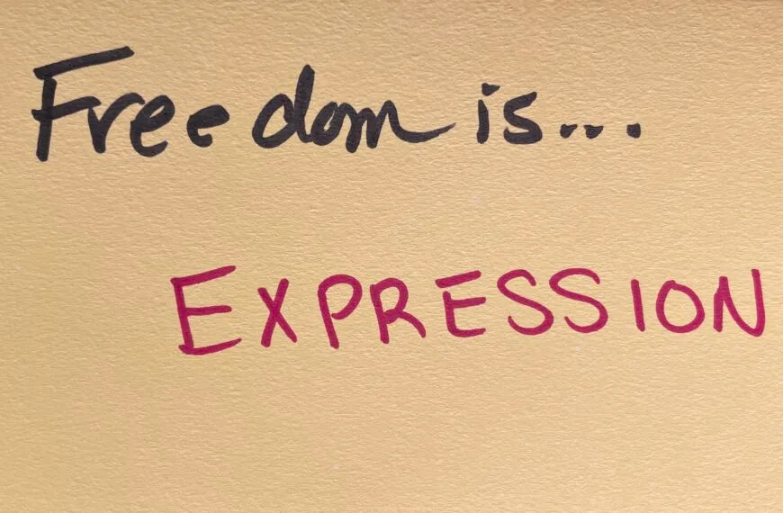 "Freedom is... EXPRESSION!" written in felt-tip marker on a beige index card. Written as a prompt for a piano improvisation concert.