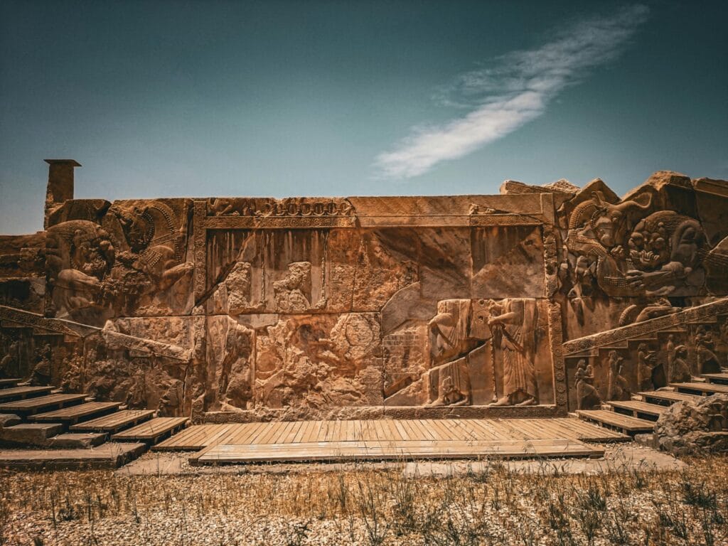 Photo of carved stone figures representing ancient Persia.