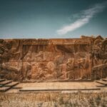 Photo of carved stone figures representing ancient Persia.