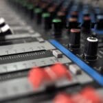 A mixing console in a recording studio represents the remix process.
