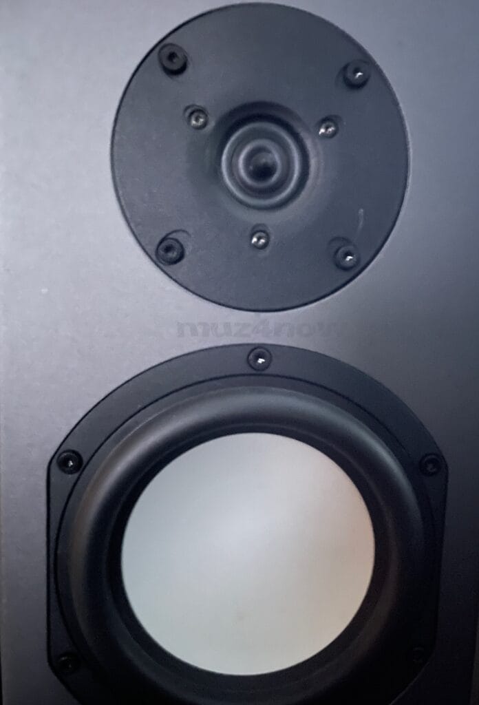 A grey, recording studio monitor. It's well worn and has heard its owner making music many times.